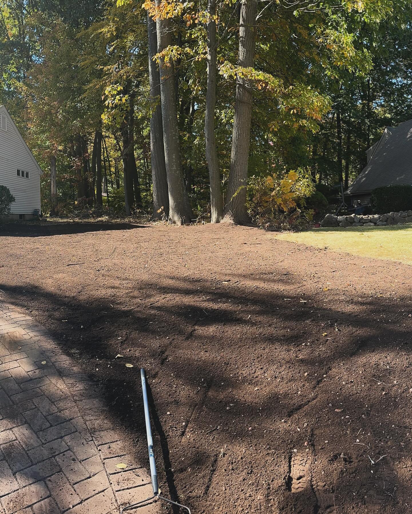 Land Clearing USA tree 6 Cleared and graded residential lot prepared for landscaping, with visible rake and smooth soil surface – USA Tree Services project in Connecticut